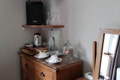 TV, chest of drawers and small dressing table